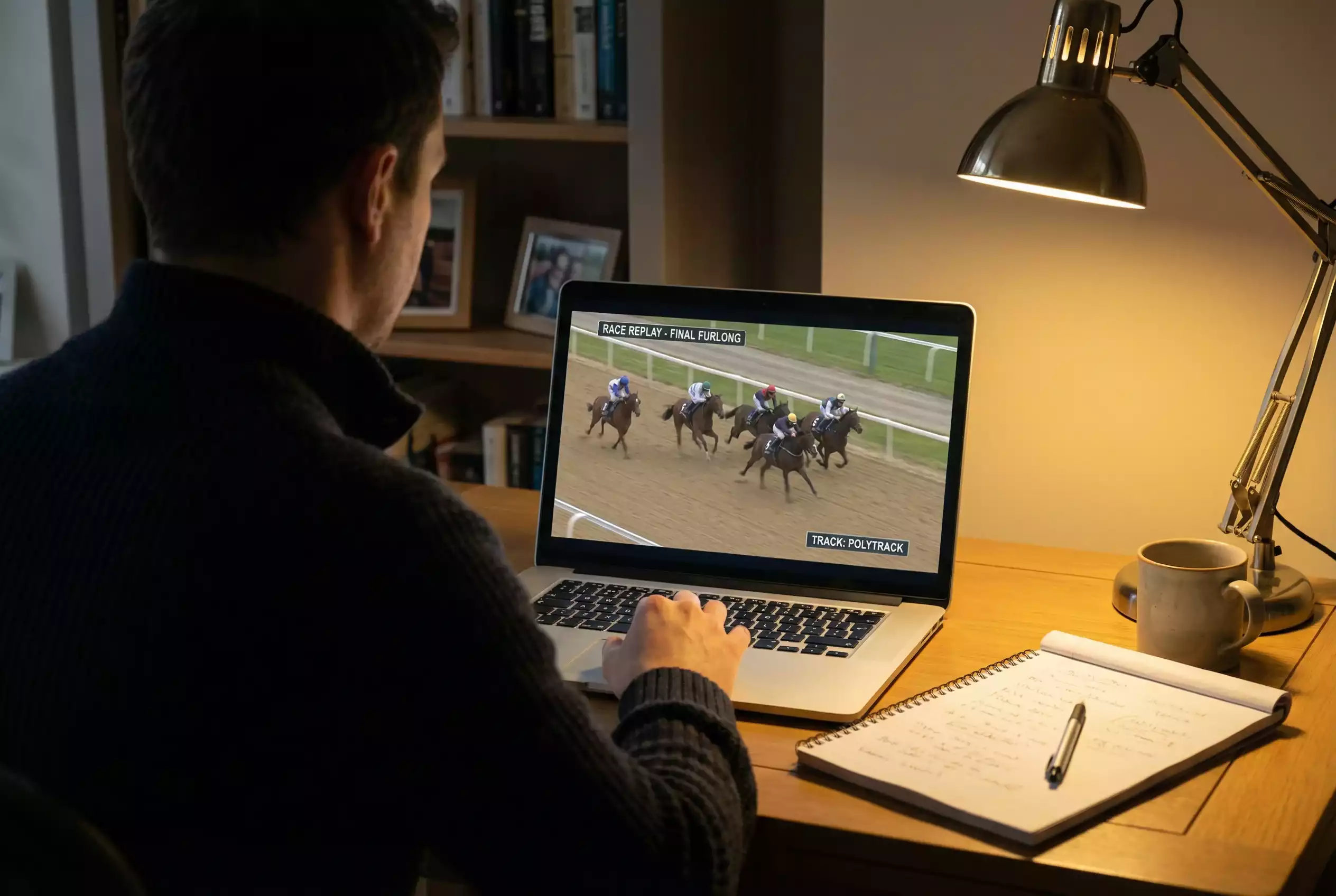 Person watching a Southwell race replay on a laptop screen for form analysis